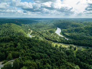 drone image. aerial view of rural area with dramatic clouds over river of Gauja in Sigulda district. Latvia