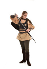 Fototapeta na wymiar full length portrait of girl wearing brown medieval costume,. standing pose, isolated on white studio background.
