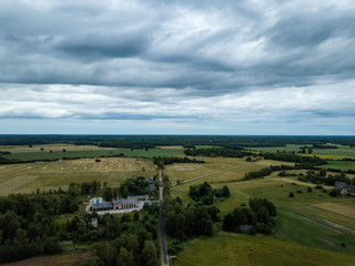 Fototapeta na wymiar drone image. aerial view of rural area with houses and roads under heavy and dark dramatic rain clouds in summer day. night photo
