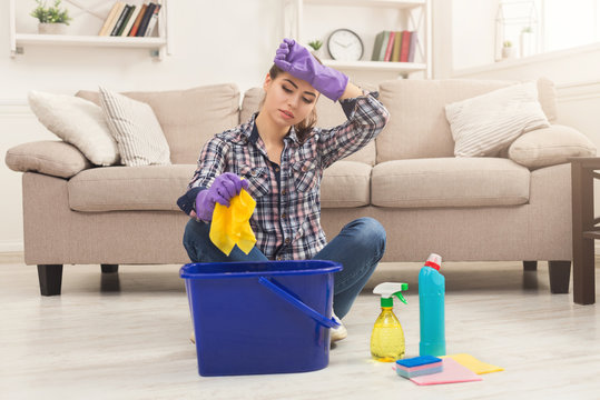 Young woman tired of spring cleaning house