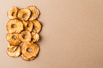 Healthy snack. Tasty dried apple rings chips on light background