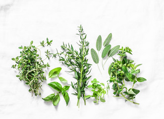 Range of fragrant garden herbs on a light background-tarragon, thyme, oregano, basil, sage, mint....
