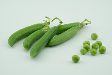 Fresh harvest green pea pods and peas from my garden on white background 