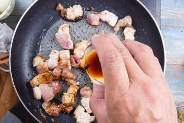 Chef put black sauce for cooking