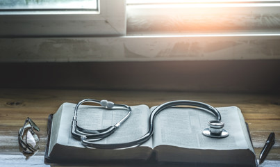 place Stethoscope on Holy bible, christian concept.