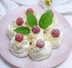 cakes made of egg white and whipped white cream with raspberries