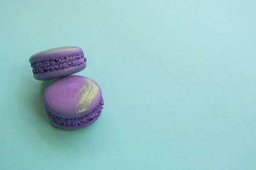 Two macaroons on blue background.