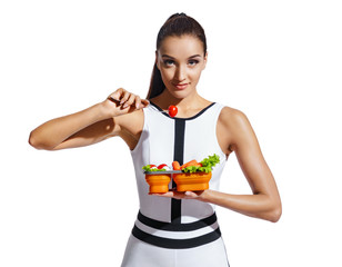 Sporty girl holding container with healthy nutrition. Photo of fitness model in fashionable...