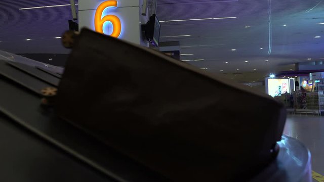 The man takes the backpack from the conveyor belt at the airport and leaves