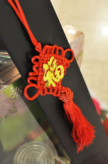 Red string Mystic Knot with chinese text translate to Prosperous 