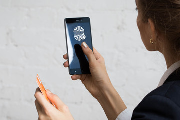 Business woman pressing button fingerprint print on phone