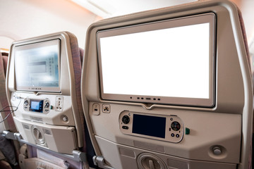 White display screen with joystick on rear seat in airplane