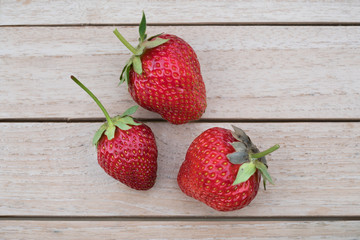 Fresh harvested homegrown strawberries from my garden on a wooden table
