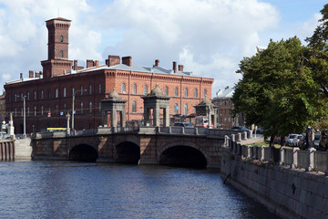 View of the river, old bridge and red brick building in St. Petersburg