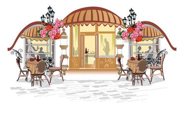 Fashion people in the street cafe. Street cafe with flowers in the old city.