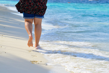 Woman walk on the beach with beautiful sea