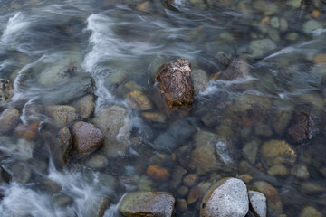 Multicolored stones under the river