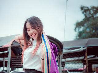 Obraz premium asian girl and graduate portrait concept from beautiful woman(20s to 30s)with long hair in graduate cloth during smile post , feel good and happy with asia city background