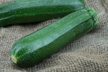 Organic homegrown green zucchini from my farm on jute background