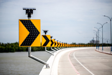 Curve road signpost with lighting on solar cell energy along the liver