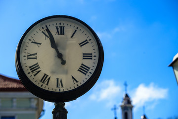 Fototapeta na wymiar Retro and vintage street clock, close-up