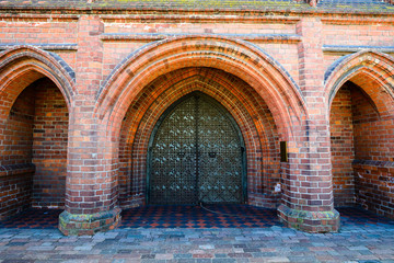 Old ancient gate in a brick castle