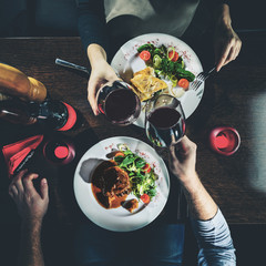 Man and woman having romantic dinner in a restaurant, toned imag
