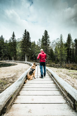 Active man with dog trekking in high mountains
