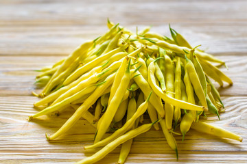 yellow beans on a wooden background.