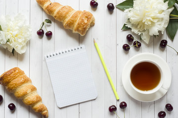 Frame custard cakes cherry peony flowers. Copy space Flat lay