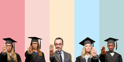 Senior teacher with his graduate students annoyed with bad attitude making stop sign with hand,...