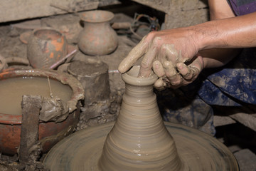 Hands of Professional Thai man using mechanic pottery made earthenware at 