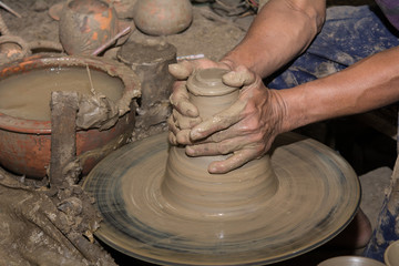 Hands of Professional Thai man using mechanic pottery made earthenware at 
