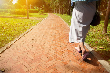 The Woman walks in the pathway