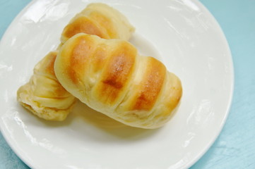bread stuffed pork sausage on white plate