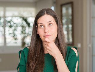 Young beautiful woman at home serious face thinking about question, very confused idea