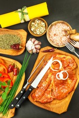 Raw marinated pork neck. Preparation of meat for grilling. Raw pork meat and spices. Fresh meat from a butcher.