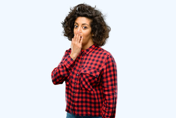 Beautiful arab woman covers mouth in shock, looks shy, expressing silence and mistake concepts, scared