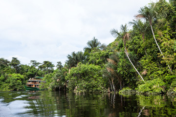 Fototapeta na wymiar Amazonas, Brazil. A traditional wooden boat on an affluent river of the Negro River in the Amazon.