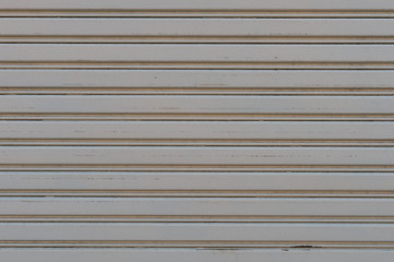 A closeup shot of automatic metal roller door used in factory, storage, garage, and industrial...