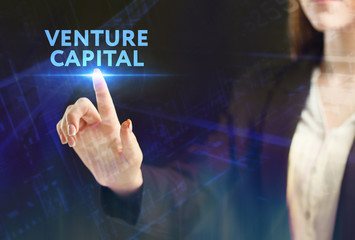 The concept of business, technology, the Internet and the network. A young entrepreneur working on a virtual screen of the future and sees the inscription: Venture capital