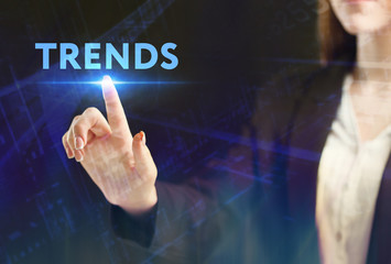 The concept of business, technology, the Internet and the network. A young entrepreneur working on a virtual screen of the future and sees the inscription: Trends