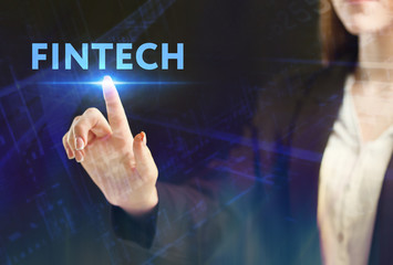 The concept of business, technology, the Internet and the network. A young entrepreneur working on a virtual screen of the future and sees the inscription: Fintech