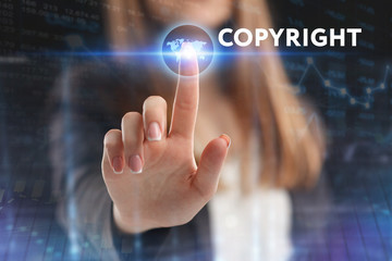 The concept of business, technology, the Internet and the network. A young entrepreneur working on a virtual screen of the future and sees the inscription: Copyright