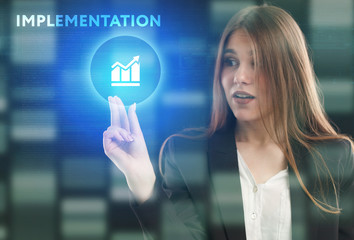 The concept of business, technology, the Internet and the network. A young entrepreneur working on a virtual screen of the future and sees the inscription: Implementation