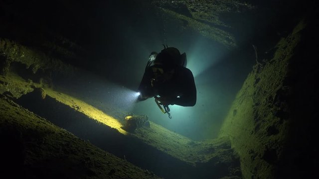 Scuba diver swims inside the shipwreck corridor - Umbria shipwreck, Red sea