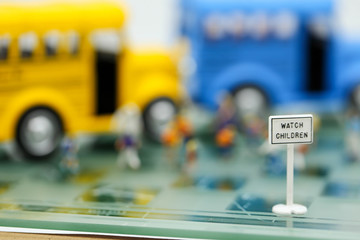 Bus stop signs with Blur of Teacher and a group of elementary school kids,schoolbus transportation education concept.