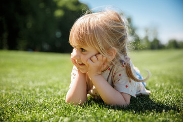 Fototapeta premium Little happy girl gardening in the summer