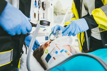 Emergency doctor taking care of seriously injured woman with neck collar after accident