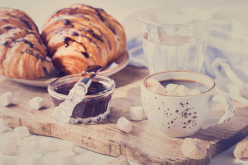 Croissant with Chocolate Espresso with Marshmallow Glass of Water Tradition Zatraq Morning Baking Sweet Dessert Toned image